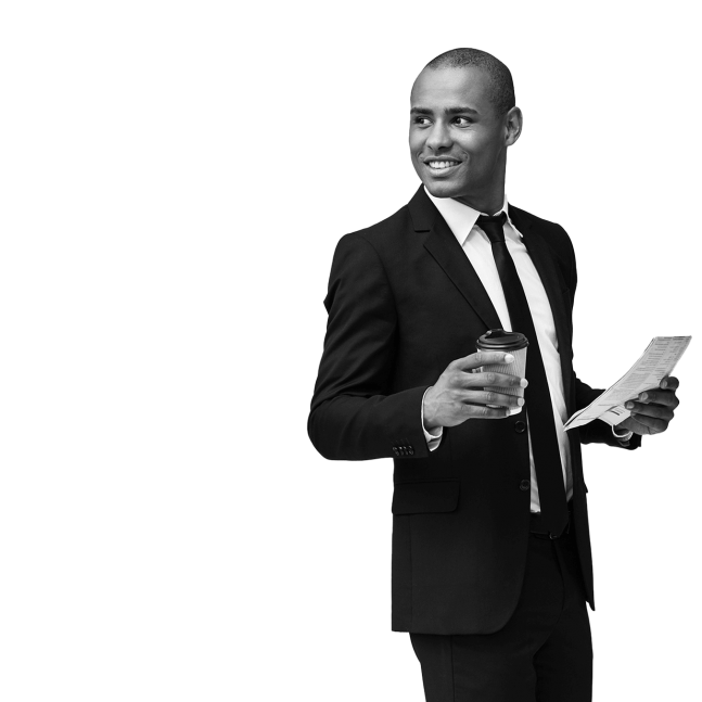Man in a dark suit and tie holding a coffee cup and a newspaper and smiling