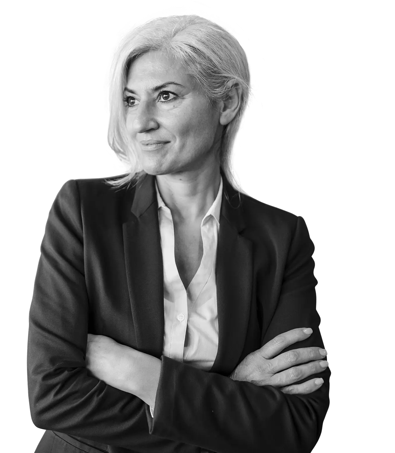 Woman with short light hair in a dark blazer standing with her arms crossed and smiling